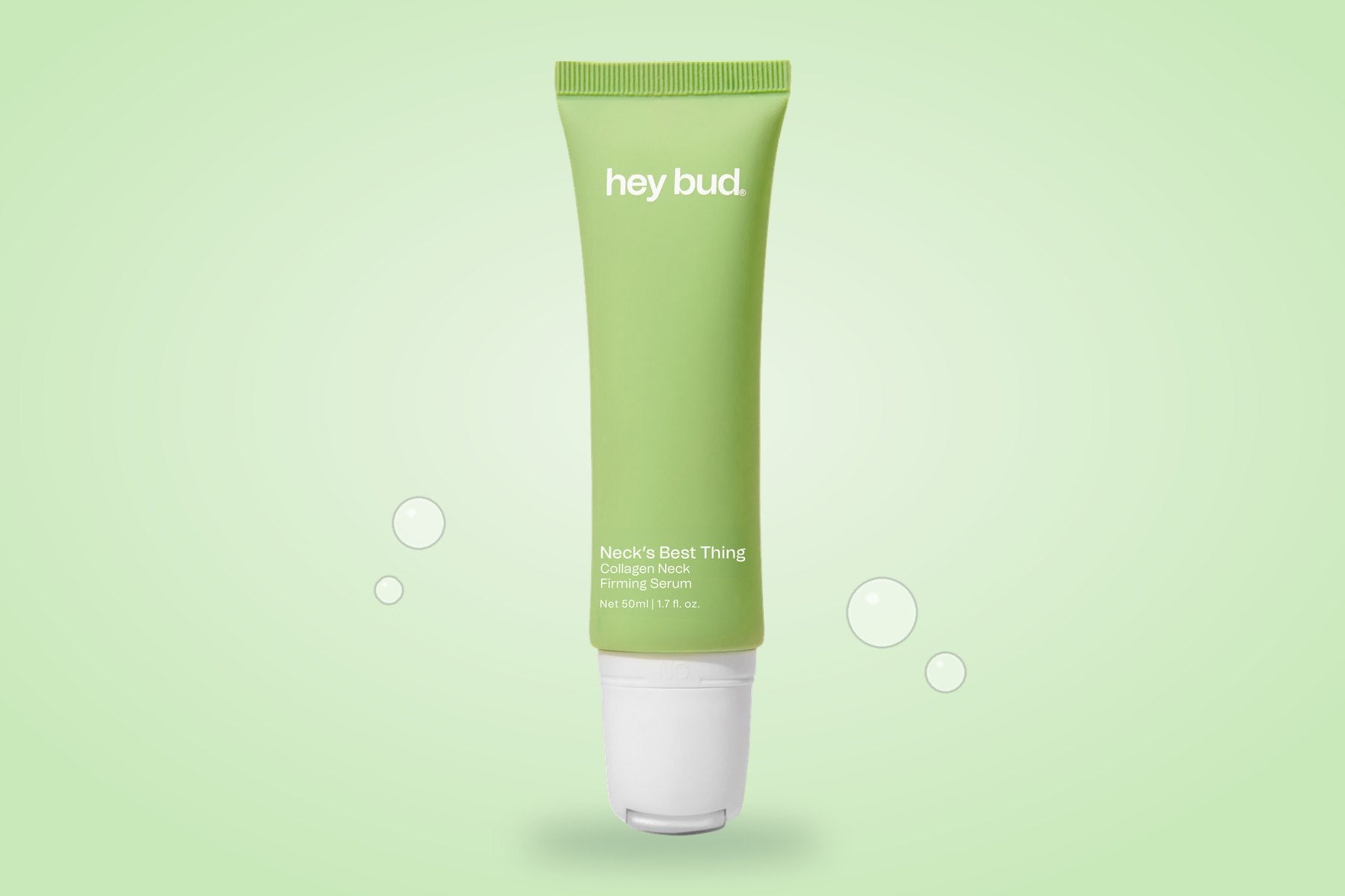 Collagen Neck Firming Serum tube on a soft green background, made with Matribust®