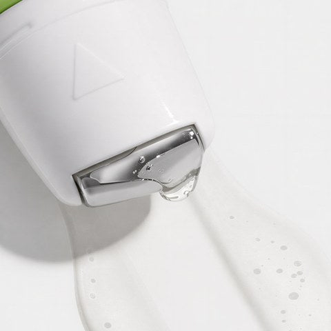 Close-up of the roller tip gliding out a clear serum