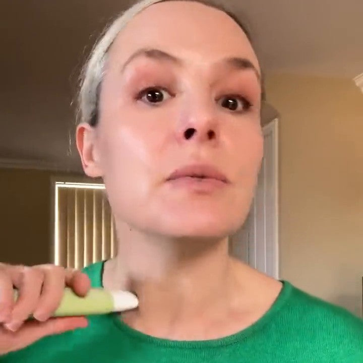 Trudi rolling the Hey Bud neck serum's cooling roller along her neck